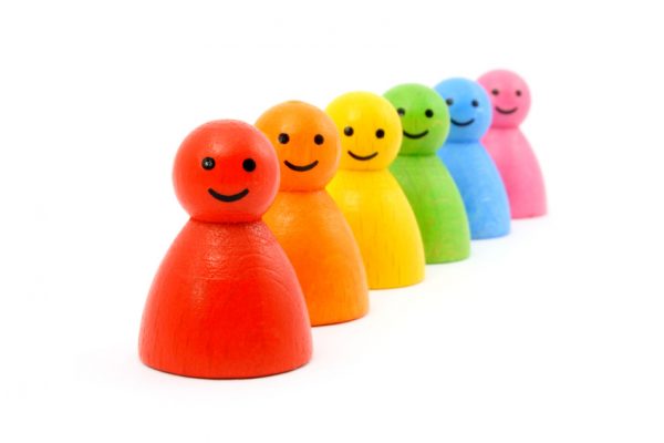 Six colorful gaming pieces smiling. Isolated on white.